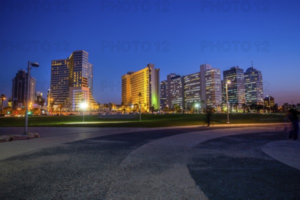 Amazing cityscape of Tel-Aviv, blurred people, luxury buildings- close to coastline ! Blue hour in Israil, awe winter journey!