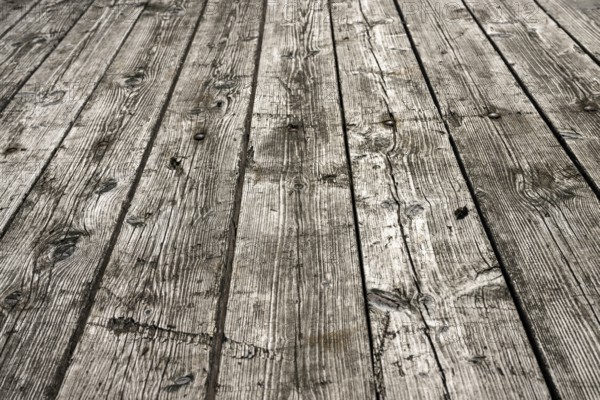 Weathered gray wooden floorboards as background photo