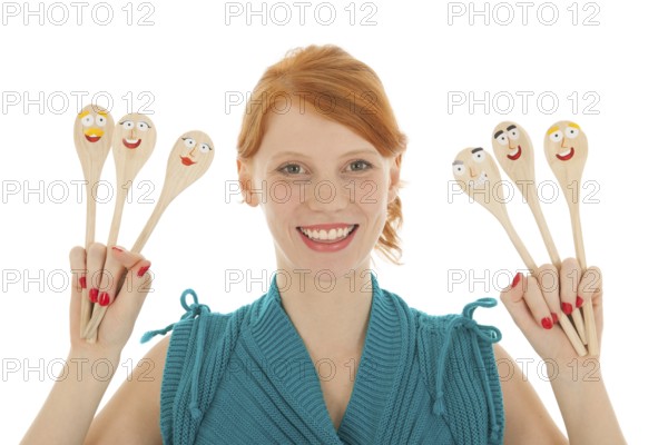 Woman cooking with funny wooden spoons
