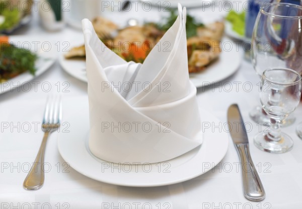 Place setting at laid restaurant banquet table
