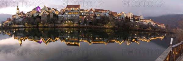 Christmas illuminated house facade of Frohnleiten reflected in the river Mur, panoramic view, Frohnleiten, Styria, Austria