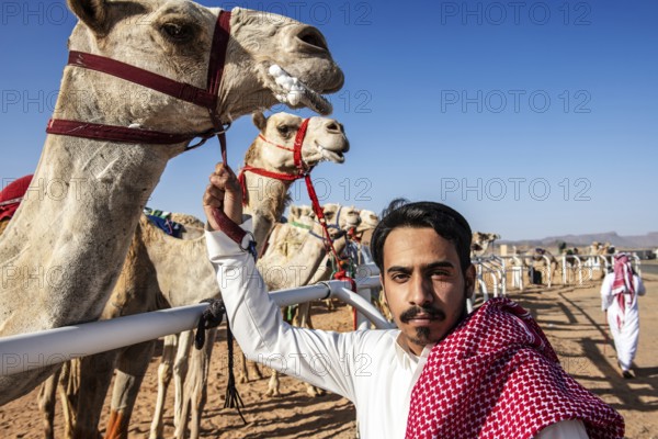 Sheikh with his racing camel at the Al Ula Camel Cup in the Mughayra Heritage Sports Village, Al Ula, Saudi Arabia