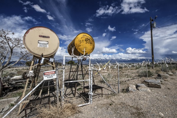 Truck stop with oil barrels and a fence of deer antlers, Highway 50, Loneliest Road in America, Ely, Nevada, USA