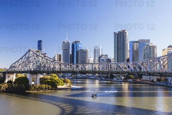 BRISBANE, AUSTRALIA, JULY 29, 2023: Brisbane skyline and Story Bridge from the suburb of New Farm and Wilson Outlook Reserve early in the morning in Queensland, Australia