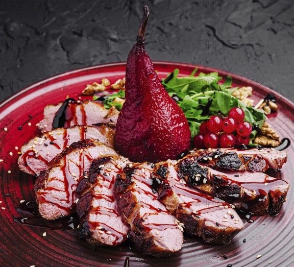 Food, A beautifully plated gourmet dish showcases succulent slices of duck, drizzled with sauce, accompanied by a poached pear, fresh greens, and vibrant berries