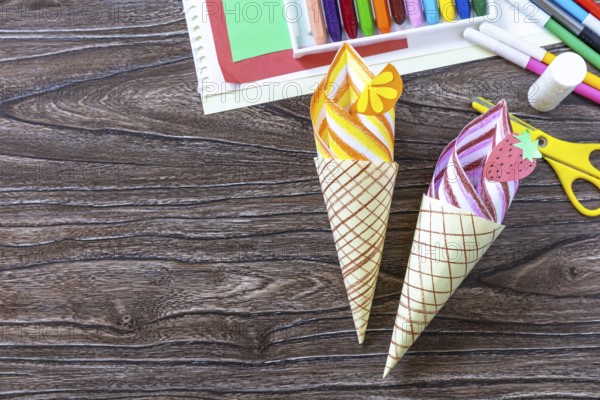 Paper Fan paper ice cream on a wooden table. Childrens art summer project, handmade, crafts for children