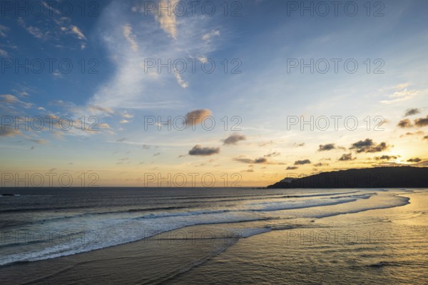 Beautiful sunset landscape at tropical beach in Lombok, Indonesia. Bright sunset landscape near Kuta beach area, Lombok, Indonesia