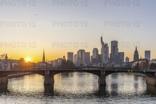 View over the river Main with a modern skyline in the background in the evening, at sunset. Beautiful overview of the city and its surroundings in Frankfurt, Hesse