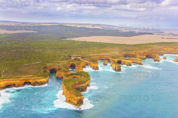 Aerial view. Helicopter flight over the scenic Pacific coastline. Australia. The Twelve Apostles are a group of limestone rocks in the Pacific Ocean near the coast. Great Ocean Road