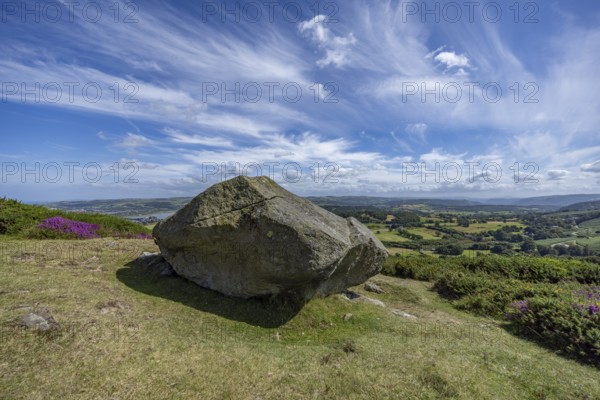 Large rock on a hill with sweeping views over a green landscape around Conwy and Conwy Castle on the edge of Snowdonia National Park, Conwy, Dwygyfylchi, Caernarfonshire, Conwy County Borough, Wales, United Kingdom