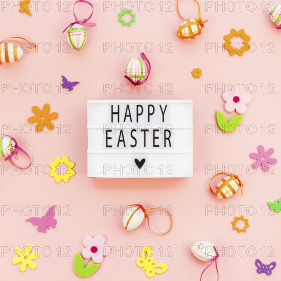 Creative Top view flat lay holiday composition Happy Easter text on lightbox pink paper background copy space Template Easter day seasonal pattern