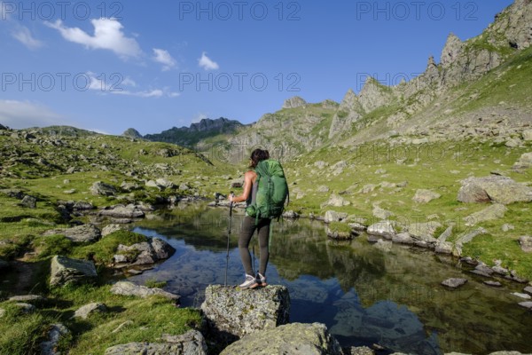 Hiker on Lac Bersau, Ayous lakes tour, Pyrenees National Park, Pyrenees Atlantiques, France