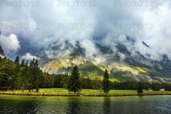 Königssee - the cleanest lake in Germany, Bavaria. Walking route along the lake shore. The lake is surrounded by high mountains. The concept of active, ecological and photo tourism