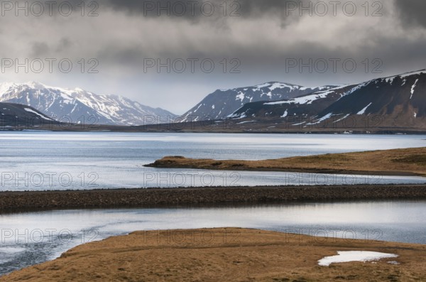 Icelandic dramatic landscape with frozen lake and mountains covered in snow at snaefellsnes peninsula in Iceland in wintertime
