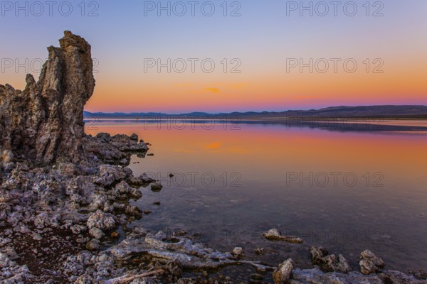Magic sunset on the lake. Lime-tuff towers of bizarre shapes rise from the bottom of the lake. The natural wonder of the world is Lake Mono. Mono Lake is a salt lake in California