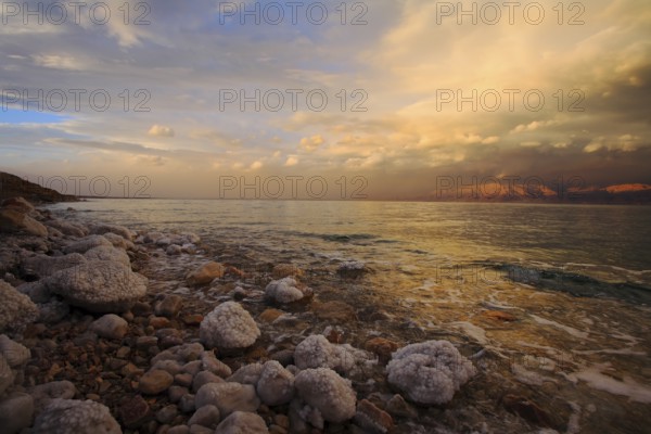 Coast of the Dead Sea in Israel in a spring thunder-storm. The coastal stones covered by salty adjournment