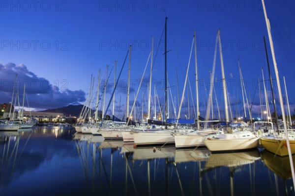 Idyllic view of sailing boats in the harbor of Palermo. Blue hour and Magic reflection in watrer. Mediterranean sea