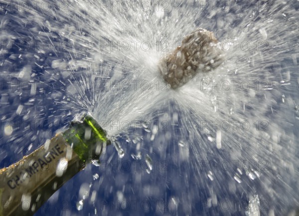 Popping cork of an opened champagne bottle