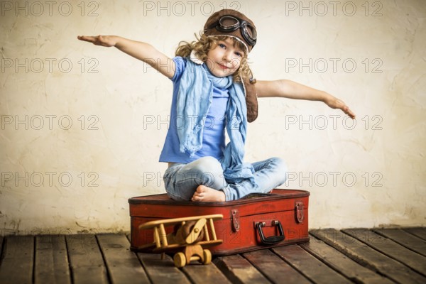 Happy kid playing with toy airplane