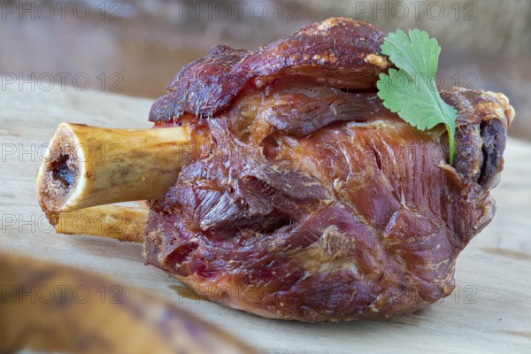 Grilled pork knuckle on a wooden board