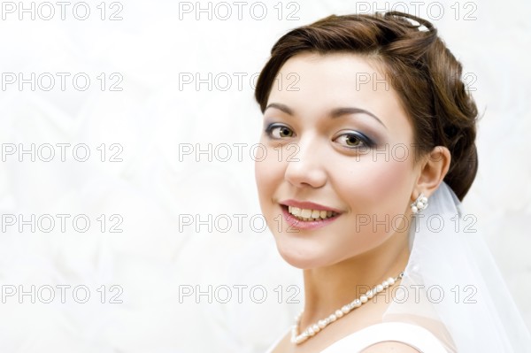 Young charming bride looks into camera, closeup