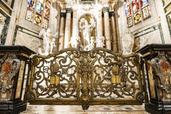 Carved gates with gilding in front of the altar of St. John in the Duomo. Milan, Italy.