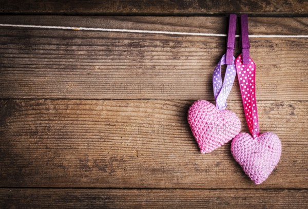 Crochet valentine hearts handing on the rope. Valentine's day greeting card. Love concept