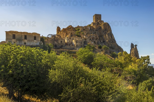 A picturesque view of the abandoned, old mountain town of Craco, built of sandstone rock. Craco is a ghost town abandoned due to an earthquake in the late 20th century. Province of Matera, Basilicata, Italy