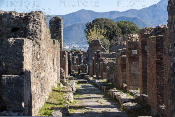 POMPEII, ITALY, MAY 04, 2022, A beautiful typical cobbled street in the ancient city of Pompeii, Southern Italy