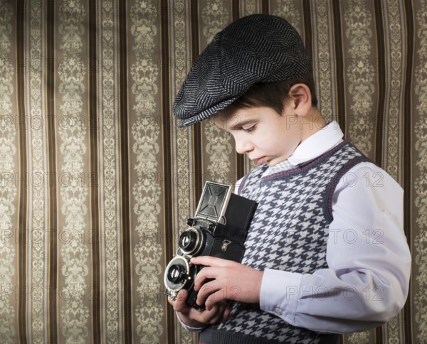Boy with vintage camera. Vintage clothes