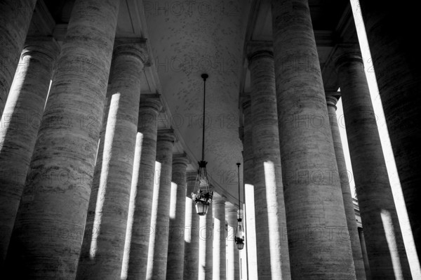 Black and white composition of columns interspersed with contrasting light, Rome