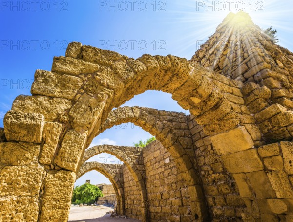Dazzling spring sun illuminates the ancient Mediterranean port. The remains of the covered arcades in Caesarea. Israel. Concept of phototourism and historical tourism