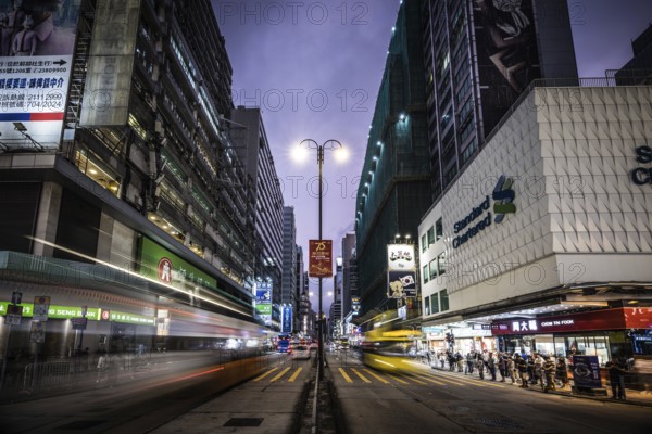 HONG KONG, CHINA - SEPTEMBER 28, 2024: Busy Nathan Rd at night with famous signage, architecture and traffic in Mongkok on Kowloon in Hong Kong