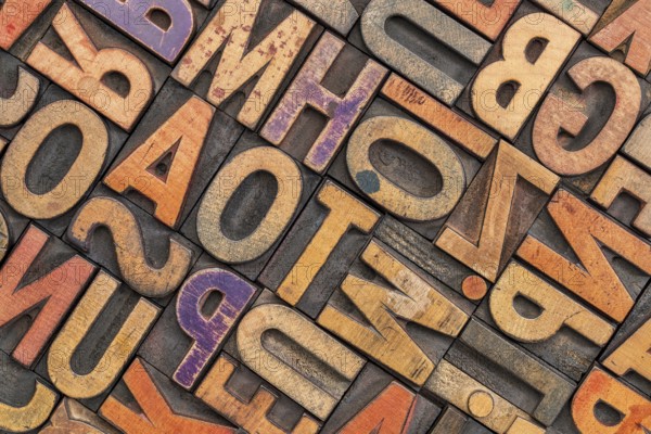 Wood type alphabet abstract with a grunge texture - letterpress printing blocks stained by color inks