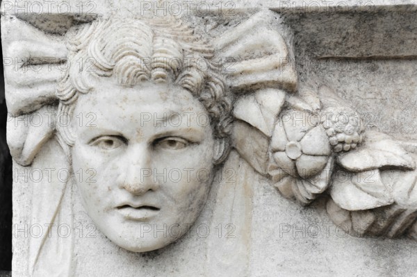 Excavation site site of the ancient city of Aphrodisias, today's city of Geyre, Karacasu, Aydin, Western Turkey, Turkey, Asia, Detail of an ancient stone sculpture with a face and ornaments, city of Aphrodisias, Caria, Aydin province