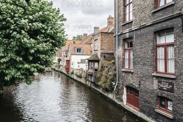 Bruges, Belgium, July 29, 2016: Canal scene in the city of Bruges. The historic city centre is a World Heritage Site of UNESCO. It is known for his picturesque cobbled lanes and dreamy canals