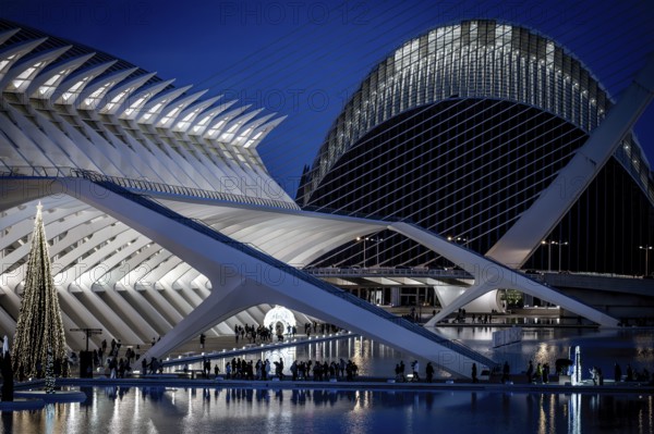 Modern architecture illuminated at night, mirrored on water, City of Arts and Sciences, Valencia, Spain