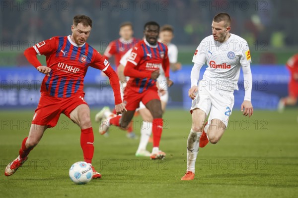 Soccer, 1st Bundesliga, Matchday 26, 2024/2025, 1. FC Heidenheim vs. Holstein Kiel, 16.03.2025, Voith-Arena, Heidenheim, Germany, Budu ZIVZIVADZE (1. FC Heidenheim, 12) in duel with David ZEC (Holstein Kiel, 26)