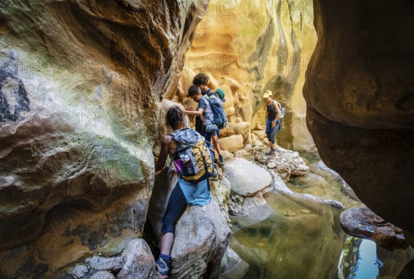 Walkers dodging waterlogged stretches, Torrent de Pareis, Sa Calobra, Majorca, Balearic Islands, Spain