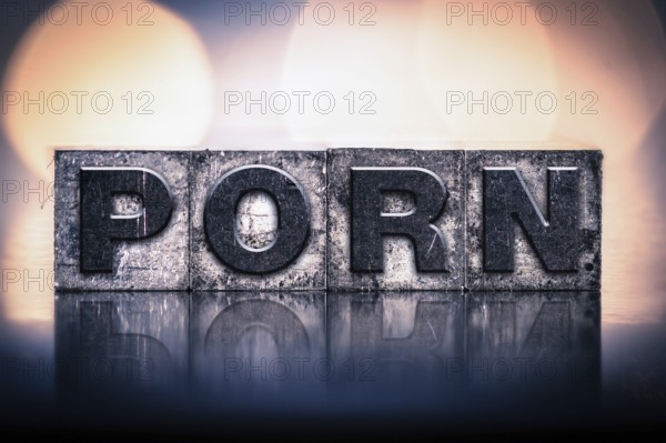 The word PORN written in vintage ink stained letterpress type