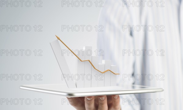 Businessman hand holding tablet with finance graph on screen