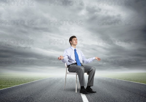 Businessman sitting on an office chair, meditation and calmness