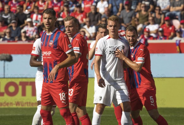 Football match, from left to right Marvin PIERINGER 1.FC Heidenheim, Lennard MALONEY 1.FC Heidenheim, Philipp LIENHART SC Freiburg and Benedikt GIMBER 1.FC Heidenheim wait excitedly for the corner kick to be taken, Voith-Arena football stadium, Heidenheim