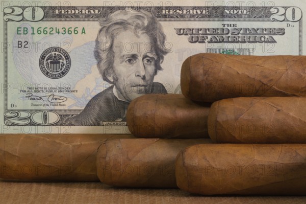 Luxury Cuban cigars with US dollar banknote on the wooden table