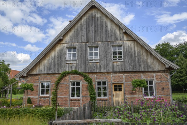 Traditional half-timbered farmhouse under a clear blue sky, burlo, münsterland, germany