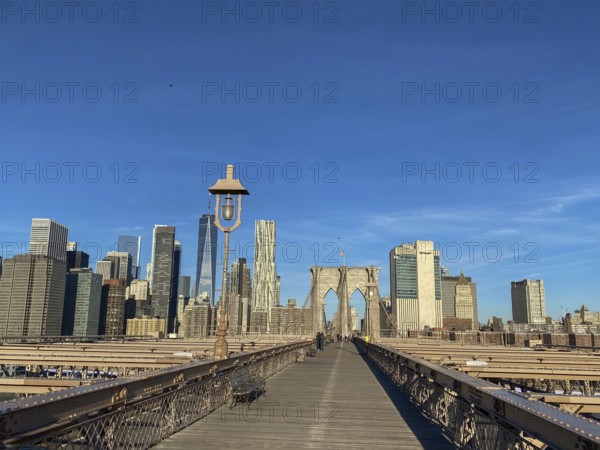 Straight view of the Brooklyn Bridge with skyscrapers and clear sky in the background, New York, USA