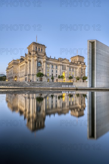 The Reichstag in Berlin at dusk, reflected in the River Spree