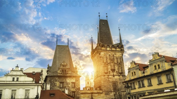 Malostranska Tower on Charles Bridge and morning sun in Prague