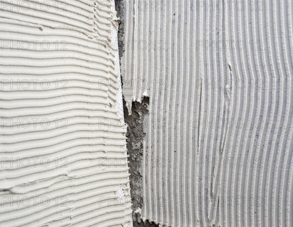 Construction notched trowel mortar shape on big tile back side