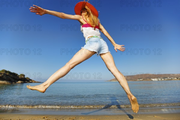 A woman jump at the beach